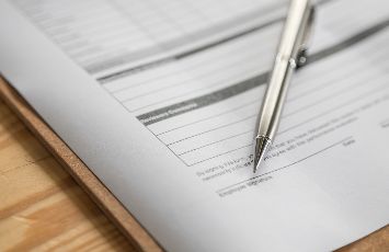  pen and forms on a clipboard