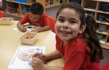  Student smiling while doing a worksheet