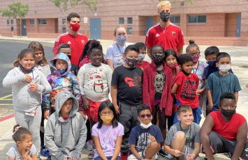  students pose for a class photo outside