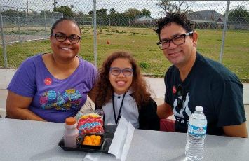  A family eats lunch at the school