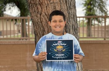  A student holds a certificate of recognition