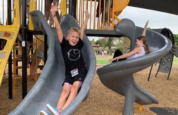  Students go down the playground slides
