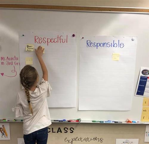 student working on a  whiteboard