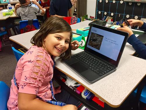 a student works on a chromebook