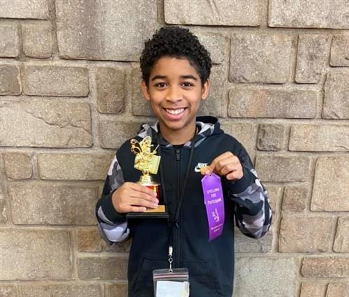 a student shows off his award