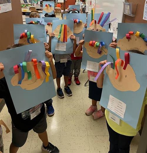 students show off artwork