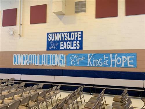 a sign is hung for the promotion ceremony