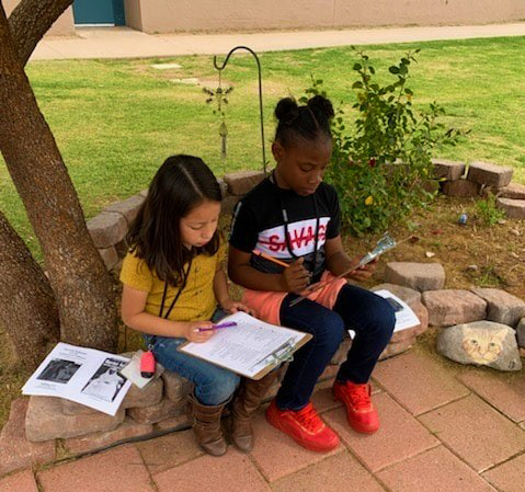 two students read outside